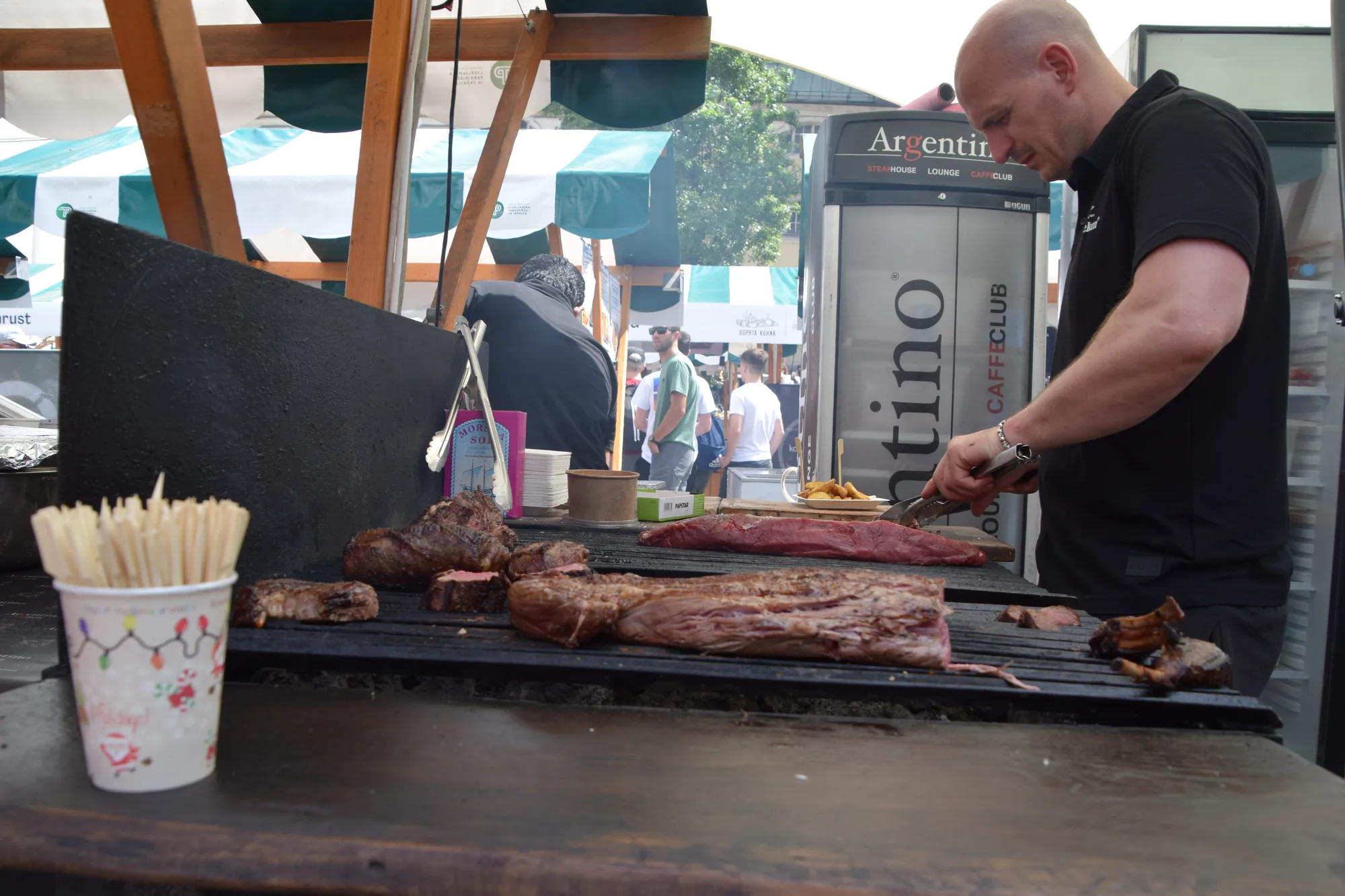 A chef grilling at the Open Kitchen (Odprta kuhna) open-air food market in Ljubljana